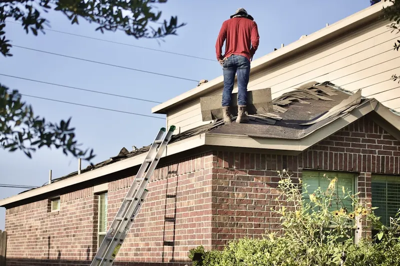 Professional roofer working on a residential roof in Goldens Bridge